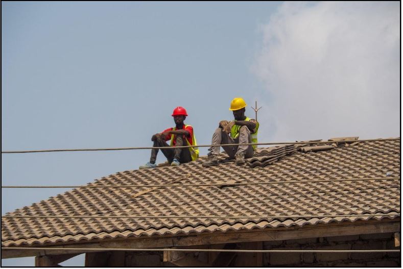 workers sitting on roof of a home in California 